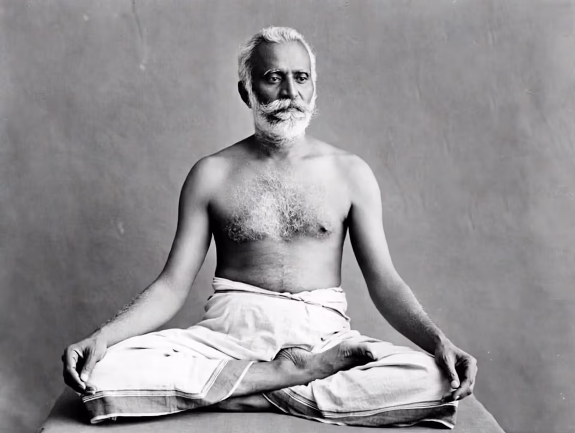 Archival portrait of Tirumalai Krishnamacharya seated cross-legged.